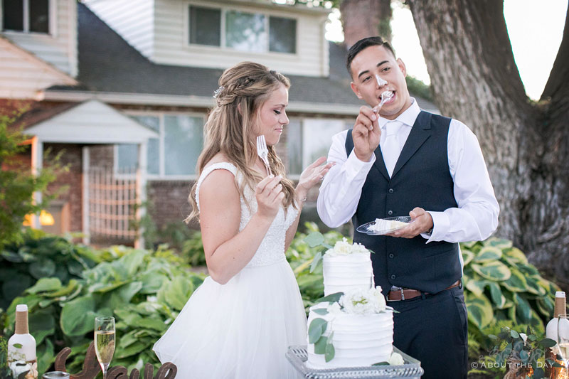 Somehow the Groom ends up with cake on his face