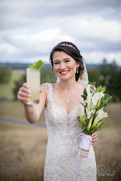 The Bride shows of her drink at The Orchard at Sunshine Hill