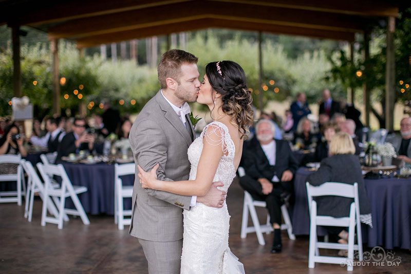 The couple kisses during their first dance at The Orchard at Sunshine Hill