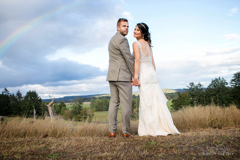 The Bride and Groom look back with a rainbow at The Orchard at Sunshine Hill