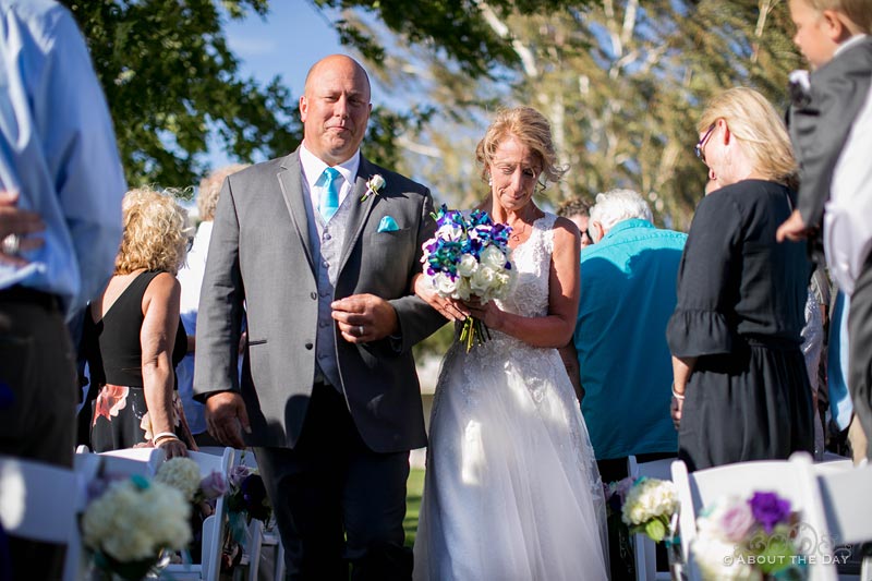 The Bride is escorted down the isle at Campbell's Resort at Lake Chelan