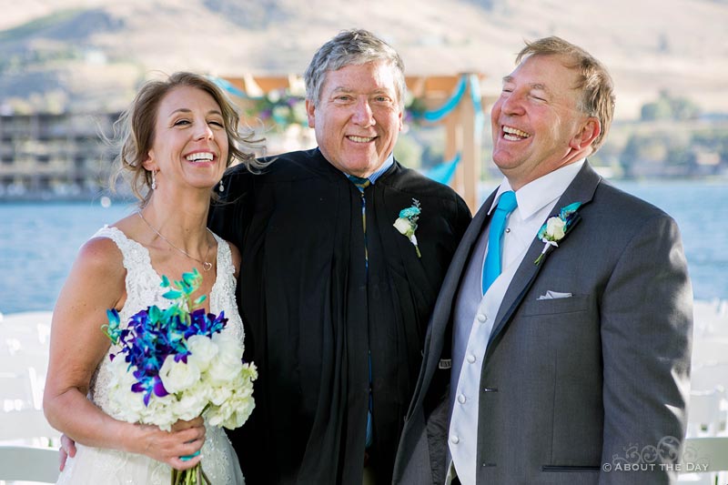 The Bride and Groom with the officiant at Campbell's Resort at Lake Chelan