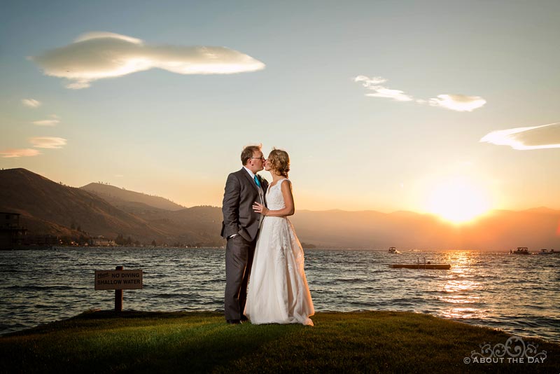 The Bride and Groom stand during a beautiful sunset at Campbell's Resort in Lake Chelan