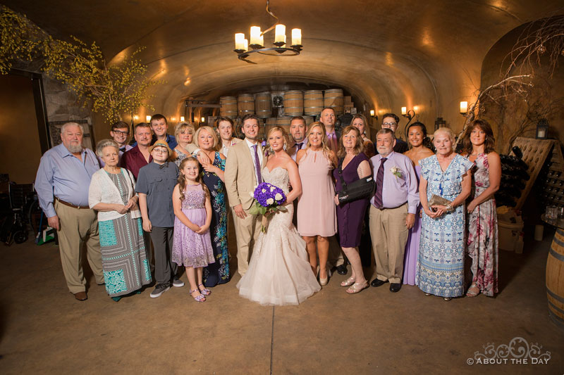 Nikita and Alexis and their full family in the cave at Karma Vineyards