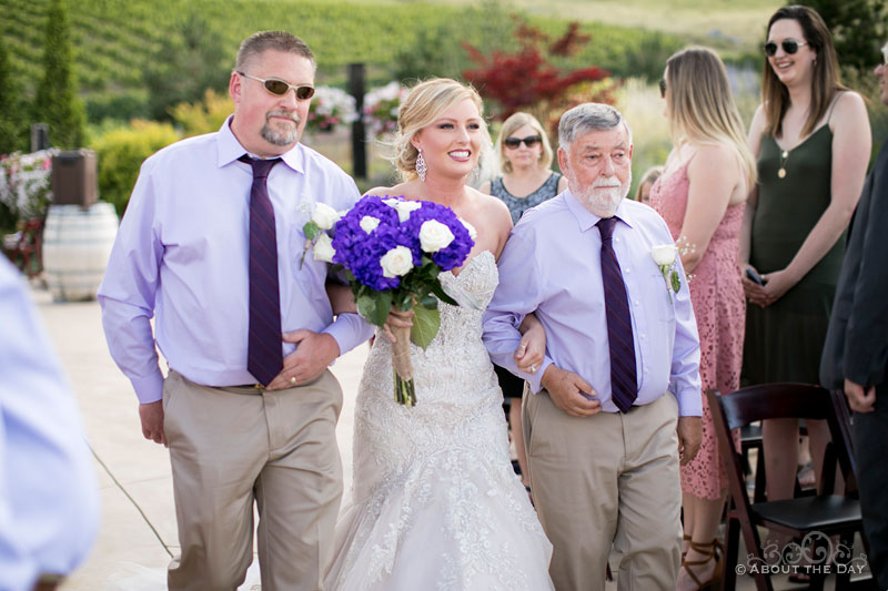 The Bride comes down the isle with her uncles at Karma Vineyards