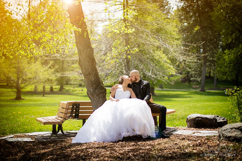 Bride & Groom kiss on bench where he proposed in Cannon Park