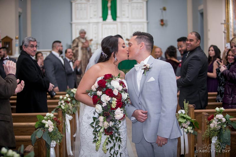 Erik and Faviola kiss while exiting St. Joseph's in Elgin, IL