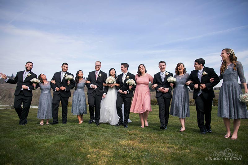 Bride and Groom walk with their wedding party at Zenith Vineyards