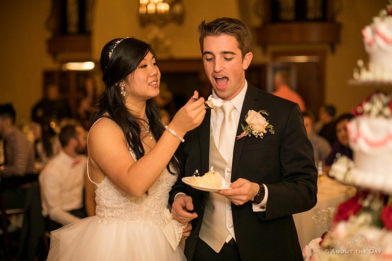 Garret & Eugenia feed each other cake at Zenith Vineyards