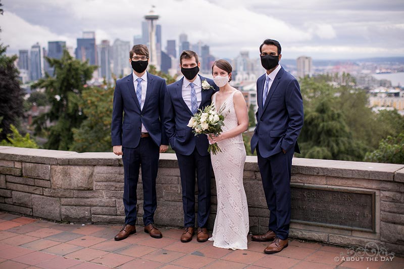 David & Vanessa with their wedding party at Kerry Park and a view of the Seattle skyline
