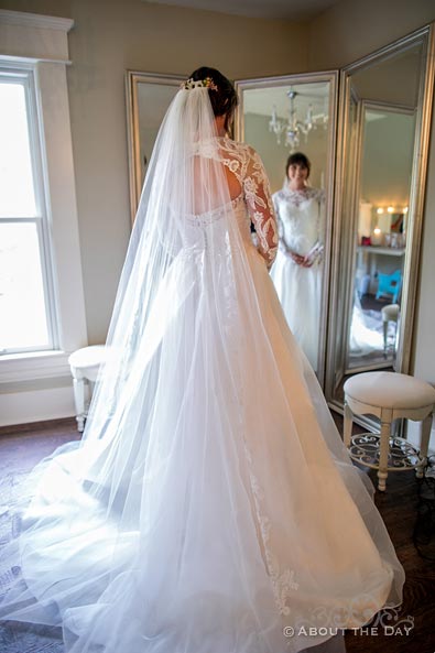Courtney views her wedding dress in the mirror