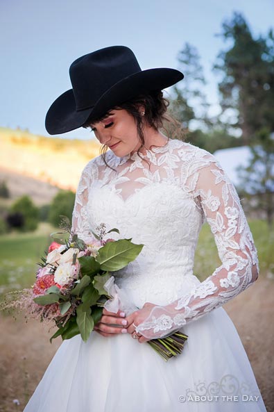 The bride looks great wearing the Groom's cowboy hat
