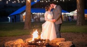 Bride & Groom kiss fireside at The Barn At Blue Meadows